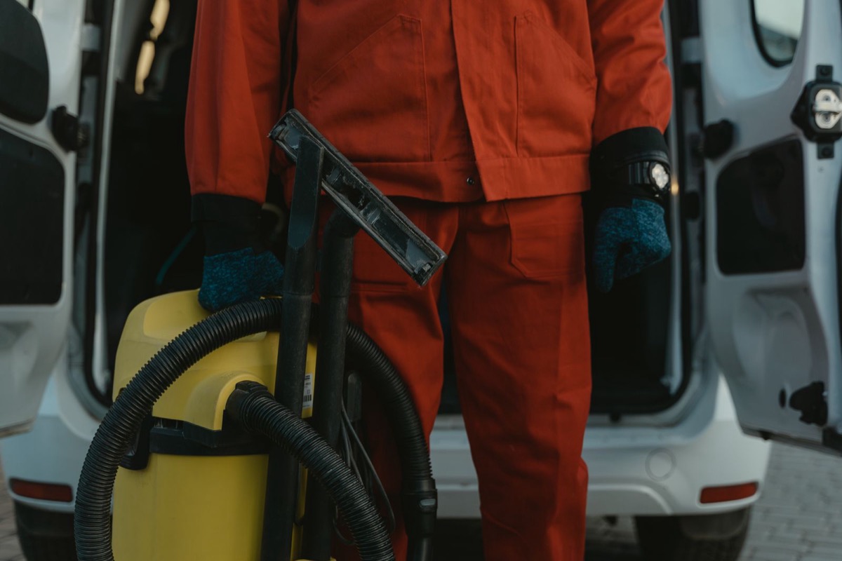 Uniformed cleaner with vacuum equipment