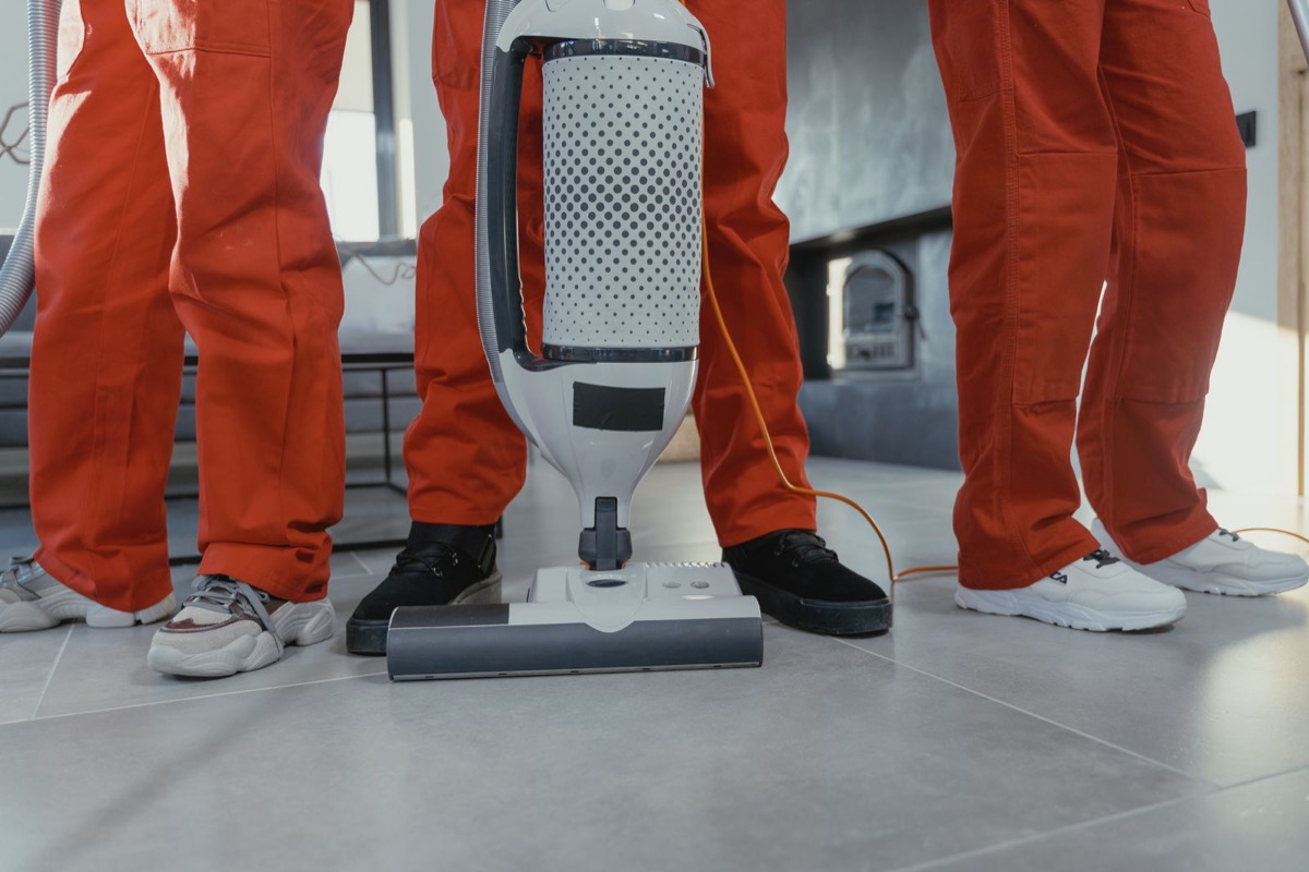 Cleaning team with vacuum equipment ready for a shift